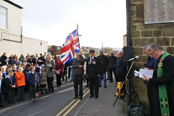 Photo 9  - 2014 Normanby Remembrance Day - The Standard Bearer (Andrew Forde) Raises the Union Flag
