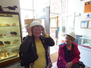 Photo 14  - Cleveland Ironstone Mining Museum - Sylvia Fairbrass adjusts her Hard Hat whilst Pat McCoy watches.